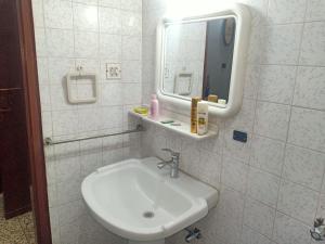 a bathroom with a sink and a mirror at Room with Separate Entrance & Parking & Fast Wifi in Islamabad