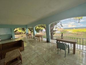 a lobby with tables and chairs and a view of the ocean at Main Stream Beach Villa in Senga