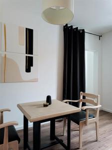 a dining room with a table and two chairs at Gallery Room 02 in Bielefeld