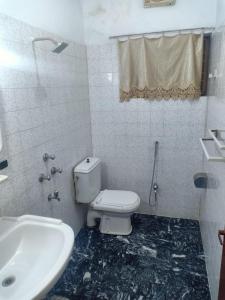 a bathroom with a toilet and a sink at Room with Separate Entrance & Parking & Fast Wifi in Islamabad