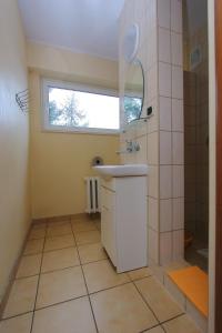 a bathroom with a sink and a window at OSW BALTIC Sopot in Sopot