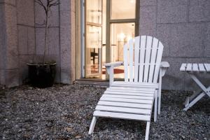 a white chair sitting in front of a building at Hotel Hasselbacken in Stockholm