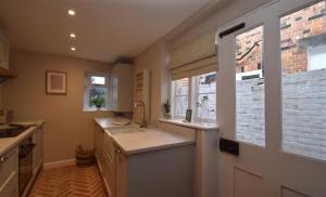 a kitchen with a sink and a brick wall at 5 East Street in Rye +23 photos