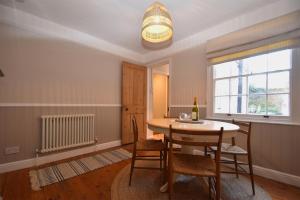 a dining room with a table and chairs and a window at 5 East Street in Rye