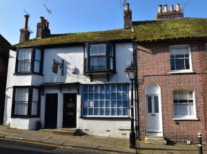 a white and red house on a street at 5 East Street in Rye