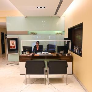 a woman sitting at a desk in an office at The Shalimar Hotel, Kemps Corner in Mumbai