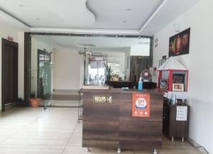 a lobby with a mirror and a counter in a room at HIMALAYA INN in Pālampur