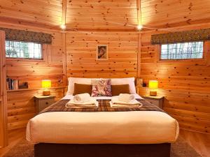 ein Schlafzimmer mit einem Bett in einer Holzhütte in der Unterkunft High Parks in Bedale
