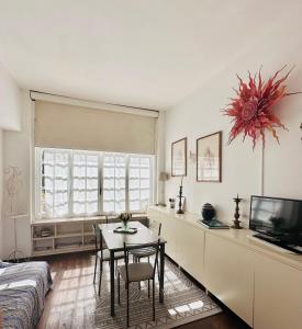 a bedroom with a table and a bed and a television at Camilluccia in Rome