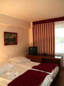 a hotel room with two beds and a television at OSW BALTIC Sopot in Sopot