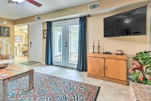 a living room with a large tv and a couch at Gulf Breeze Vacation Rental 5 Mi to Beach! in Gulf Breeze