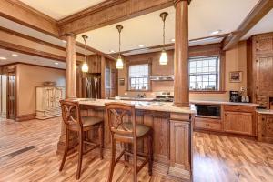 a kitchen with a large island with bar stools at Roomy Vacation Rental in Downtown Fort Wayne! in Fort Wayne