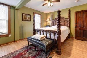 a bedroom with a large bed with a wooden frame at Roomy Vacation Rental in Downtown Fort Wayne! in Fort Wayne