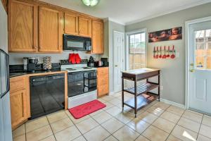 a kitchen with wooden cabinets and a stove top oven at Pet-Friendly Lafayette Vacation Rental! in Lafayette