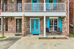 a brick house with blue doors and a balcony at Pet-Friendly Lafayette Vacation Rental! in Lafayette