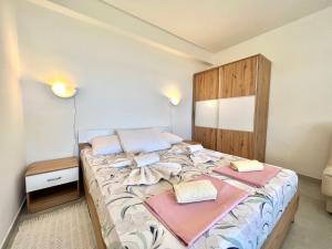 a bedroom with a bed with two pillows on it at Apartments Kate in Dramalj
