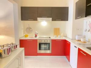 a kitchen with red cabinets and a stove at Modern apartment,24/7 security,free parking in Belgrade