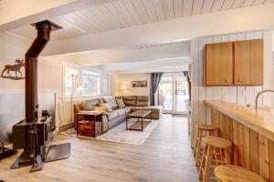 a kitchen and living room with a stove at Cozy Condo Near Golf, 7 Mi to Big Sky Resort! in Gallatin Gateway