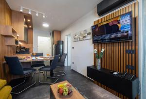 salon ze stołem i telewizorem na ścianie w obiekcie Jazine lux apartment E&T w mieście Zadar