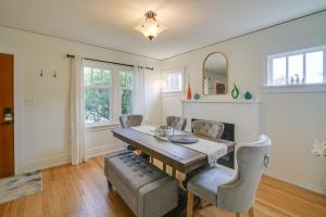 a dining room with a wooden table and chairs at Charming Tacoma Vacation Home with Fenced Yard in Tacoma