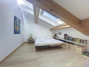 Zimmer im Dachgeschoss mit einem Bett und einem Dachfenster in der Unterkunft Nestor&Jeeves - NICE TO MEET YOU - Central - Top floor in Nizza