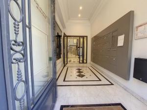 a hallway with a door and a tile floor at Nestor&Jeeves - NICE TO MEET YOU - Central - Top floor in Nice