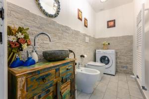 a bathroom with a sink and a washing machine at Villa Marino in San Baronto +68 photos