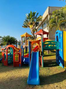 a playground with colorful equipment in a park at Aconchegante apartamento no lago in Brasilia