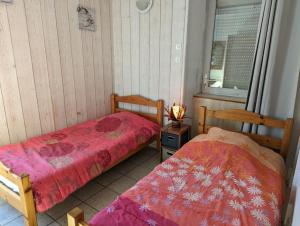 two beds sitting next to each other in a room at Gîte Olivier in Vals-les-Bains