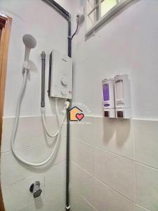 a shower in a bathroom with a microphone at WIRA HOMESTAY KUANTAN in Kuantan