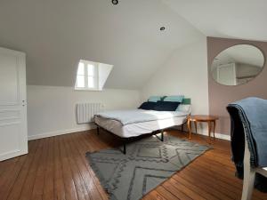 a bedroom with a bed and a mirror on the wall at Sur les toits de Fontainebleau - Hypercentre in Fontainebleau +22 photos