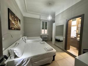 a bedroom with two beds and a mirror at Hotel Bogart in Milan