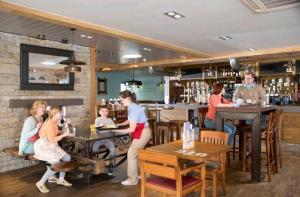 a group of people sitting at tables in a restaurant at Beautiful caravan near Edinburgh Seton Sands nr117 in Longniddry