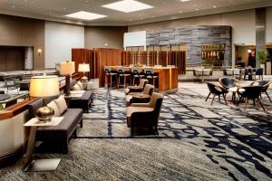 a lobby with couches and chairs and a bar at Marriott Cincinnati Airport in Hebron