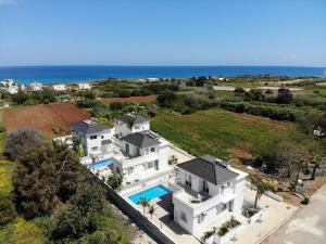 an aerial view of a house with a swimming pool at Flouressia Gardens in Protaras