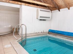 a swimming pool in a bathroom with a bath tub at 12 person holiday home in Hvide Sande in Havrvig