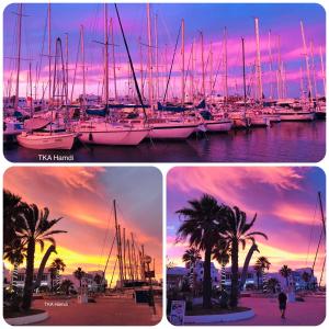 a group of boats docked in a marina with a sunset at Private Apartment at Marina Monastir in Monastir