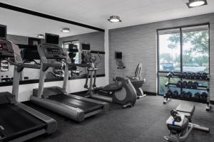 a gym with treadmills and machines in a room at Courtyard by Marriott Jacksonville I-295/East Beltway in Jacksonville