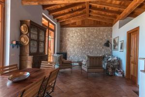 a living room with a wooden table and chairs at Villa Limone in Limone sul Garda +27 photos