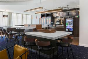 a bar in a restaurant with a counter and stools at Courtyard Austin Airport in Austin