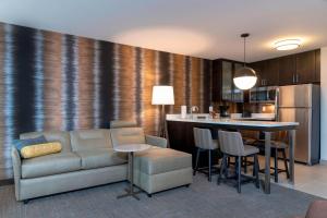a living room with a couch and a kitchen at Residence Inn by Marriott Lafayette in Lafayette