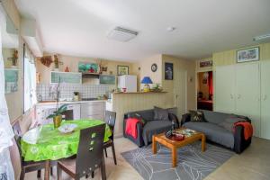 a living room with a couch and a table at Gite des landes de la houssais in Guichen