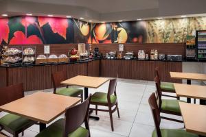 a restaurant with tables and chairs and a counter at Fairfield Inn by Marriott Loveland Fort Collins in Loveland