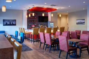 a restaurant with colorful chairs and a bar at TownePlace Suites by Marriott Cleveland Solon in Solon