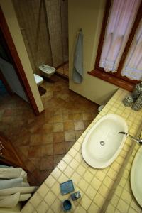 a bathroom with a white sink and a shower at Villa Limone in Limone sul Garda