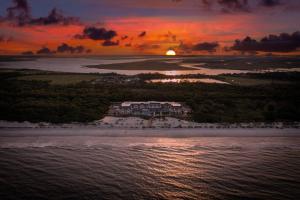 an aerial view of a resort on the beach at sunset at Courtyard by Marriott Jekyll Island in Jekyll Island