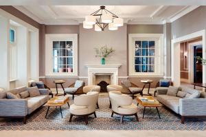 a living room with couches and chairs and a fireplace at Bournemouth Highcliff Marriott Hotel in Bournemouth