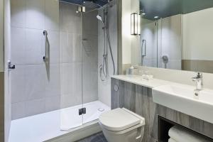 a bathroom with a shower and a toilet and a sink at Bournemouth Highcliff Marriott Hotel in Bournemouth