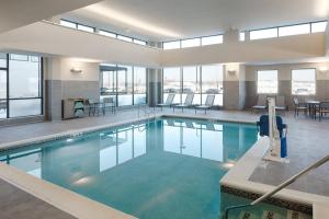 a large pool with blue water in a building at Residence Inn by Marriott Columbus Airport in Columbus