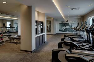 a gym with a row of treadmills and a row of treadmsktop at Residence Inn by Marriott Columbus Airport in Columbus